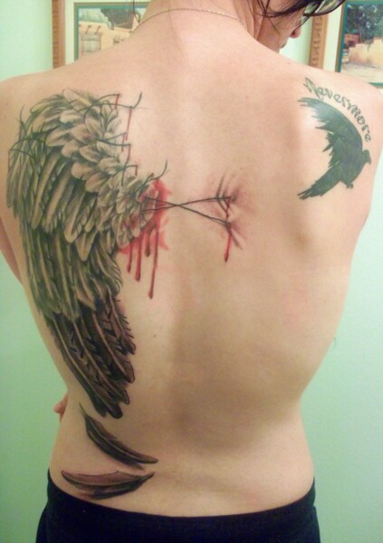 Raven tattoo on the right upper arm.